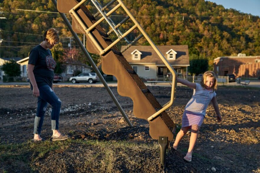 Cynthia Gooch and her niece in an unfinished park in Pineville. Pineville and other towns in Bell County have struggled with unemployment and poverty.