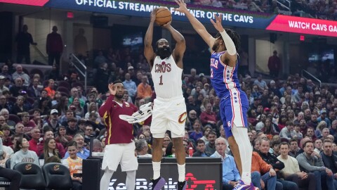 Cleveland Cavaliers guard James Harden (1) shoots as Philadelphia 76ers forward Trendon Watford (12) defends and teammate Donovan Mitchell, left, looks on in the first half of an NBA basketball game in Cleveland, Monday, March 9, 2026. 