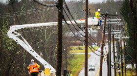 FILE: An Eversource crew on Route 44 in Bolton, Ct. repairs damaged power lines, December 18, 2023, as strong winds and heavy rain across Connecticut left more that 75,000 people without power, closed schools and snarled traffic.