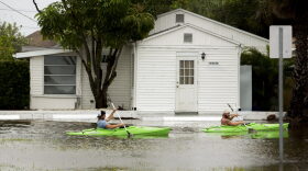 Kayakers paddle south down Palm Street in Madeira Beach, Fla., in flooding from Tropical Storm Colin, Monday, June 6, 2016. (Cherie Diez/The Tampa Bay Times via AP)