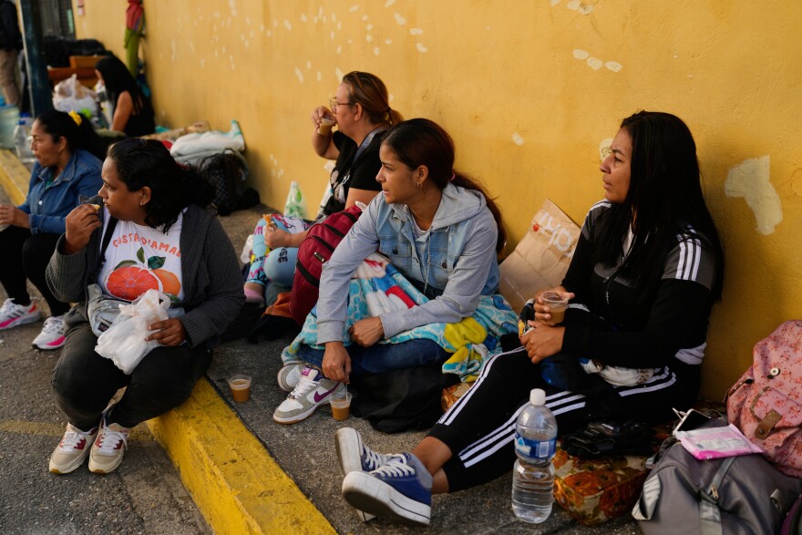 Relatives wait outside Zone 7 of the Bolivarian National Police, where political detainees are held, after spending the night there in Caracas, Venezuela, Monday, Jan. 12, 2026.