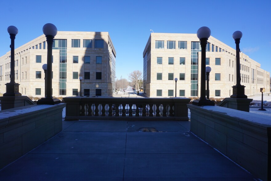 The office buildings behind Capitol building in Cheyenne, snow on the ground, clear skies