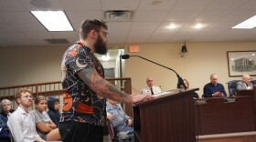 Caleb Hogan (center, at podium) spoke in opposition to the "Urban Camping" ordinance and questioned how penalizing people for sleeping outdoors will help the city's homeless population. 