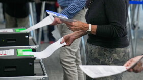 Voters enter their ballots into scanners at early in-person voting in Cleveland, Wednesday, Oct. 7, 2026.