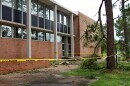 Yellow caution tape surrounds the exterior of the University of New Orleans' Science Building on Thursday, June 18, 2026. The building was damaged by strong winds brought in by post-tropical storm Arthur in the early morning. The winds blew out a window and tore off a piece of the metal roof on the university's amphitheater. Trees, including large hardwoods, were down across the Gentilly campus, some ripped out at the roots.