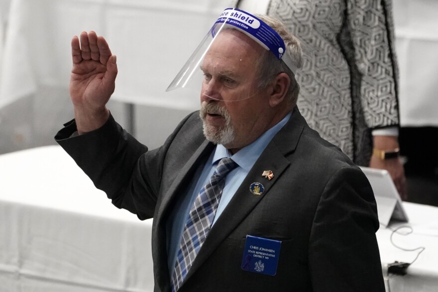 State Rep. Chris Johansen, R- Monticello, wears a face shield as he takes the oath of office at the Augusta Civic Center, Wednesday, Dec 2, 2020, in Augusta, Maine.