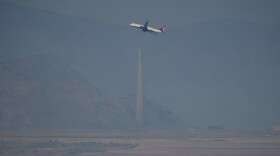 A passenger jet takes off in a dusty, hazy Salt Lake Valley in July 2024. The EPA has signaled its intent to revote a "serious" classification for northern Utah's summertime ozone pollution.