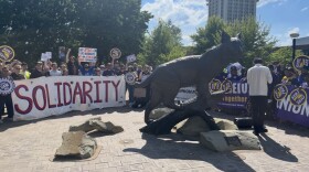 Labor groups including United Campus Workers, Service Employees International Union, United Auto Workers and the American Federation of Teachers were in attendance during a Monday rally protesting against the potential outsourcing of campus jobs at the University of Kentucky.