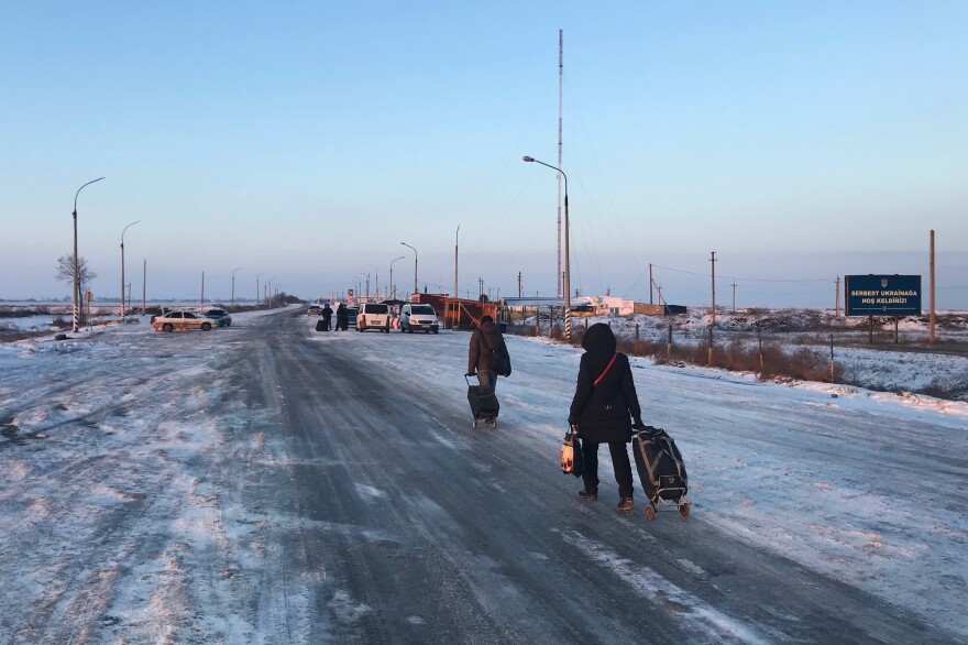 People cross from Russian-controlled Crimea to the Ukrainian mainland at a border post outside the town of Chonhar in January 2015.