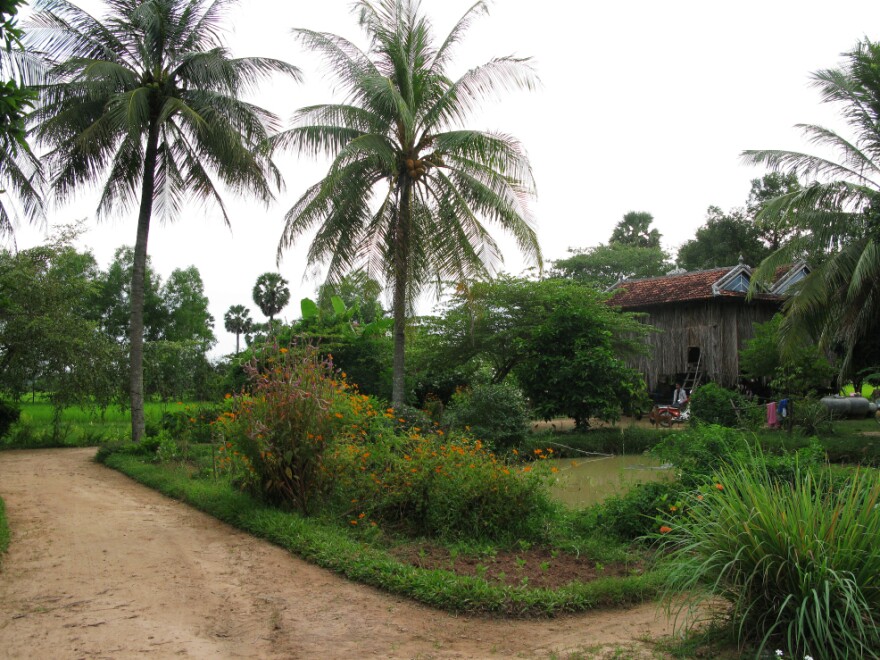 <p>Peou Nam's traditional Khmer farmhouse on stilts in the countryside of Kampot province. Peou settled there after surviving the Khmer Rouge's attempts to execute him. He remarried and has six children with his second wife.</p>