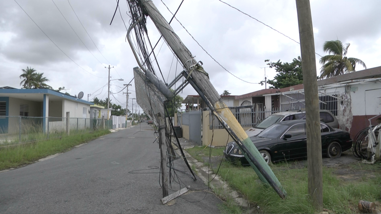 Victor Cartagena has two cars parked outside his house in Toa Baja.