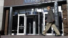 A man walks past health insurer Anthem's corporate headquarters in Indianapolis, Thursday, Feb. 5, 2015. Hackers broke into the company's database storing information for about 80 million people in an attack bound to stoke fears many Americans have about the privacy of their most sensitive information