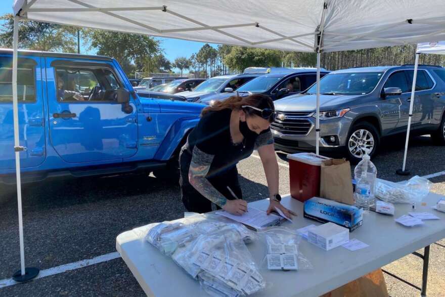 Orlando Health critical care paramedic Tracy Harden works to vaccinate people in Clermont earlier this month. Photo: Joe Byrnes