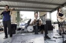 FILE - Savoy family members, Joel Savoy on fiddle, his father, Marc Savoy, on accordion and mother, Ann Savoy, play traditional Cajun music mixed with some contemporary tunes, Sept. 17, 2005, at the Festivals Acadiens in Lafayette, La.