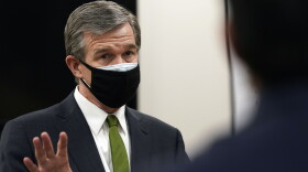 North Carolina Gov. Roy Cooper speaks during a tour of Piedmont Health Senior Care, a federally qualified health center where PACE patients (Program of All-Inclusive Care for the Elderly) and underserved populations receive the coronavirus vaccine Thursday, Jan. 28, 2021 in Pittsboro, N.C. 
