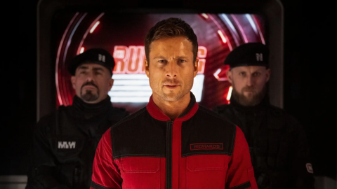 Still from the 2025 film The Running Man, featuring actor Glen Powell as his character Ben Richards [pictured at center].