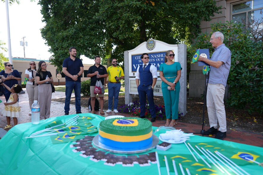 Mayor Jim Dochness reads a proclamation to members of the Brazilian community.