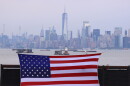 An American flag hangs in front of lower Manhatten in New York.