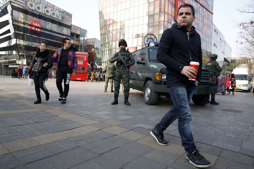 Heavily armed Chinese paramilitary police guard a popular mall in the Sanlitun district of Beijing, China, on Thursday.