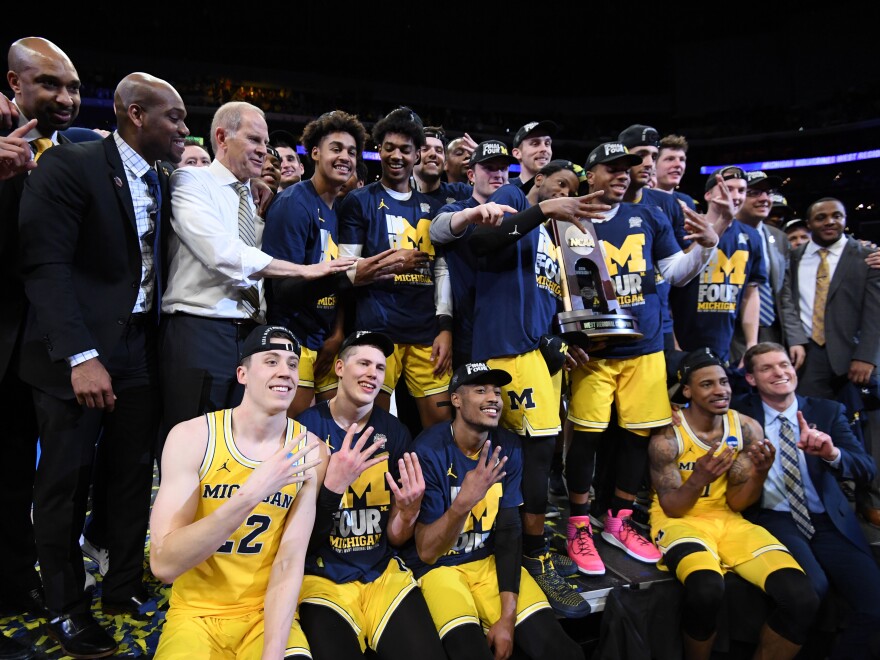 The Michigan Wolverines celebrate after defeating the Florida State Seminoles 58-54 at the Staples Center in Los Angeles on March 24. Coach John Beilein has led the team to 13 straight wins and now the Final Four.