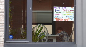 A child sits at a table in an apartment with a window sign thanking workers on March 25, 2020 in New York (Angela Weiss/AFP/Getty Images)