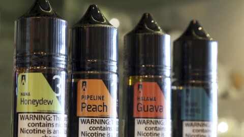 This Wednesday, March 27, 2019 photo shows a selection of e-liquid flavors like Hana Honeydew and Pipeline Peach on a counter at a VOLCANO Fine Electronic Cigarettes store in Aiea, Hawaii.