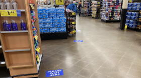 Stickers on the floor of a Kroger in Bloomington, Indiana, show how far apart customers should stand in checkout lines.