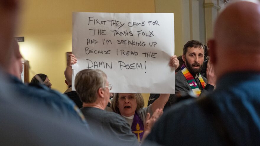 Protesters demonstrate March 10, 2026, outside the Senate chamber in the Kansas Statehouse.