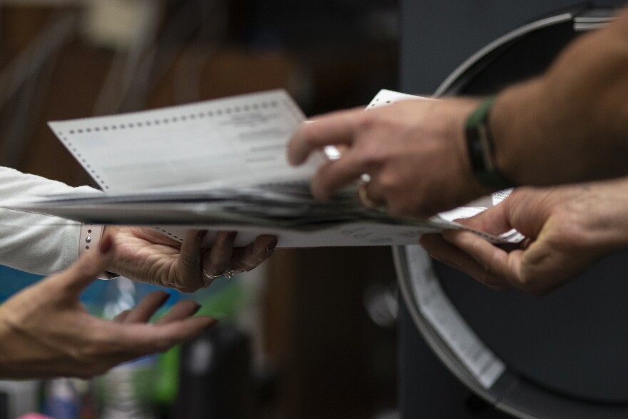 Poll workers sort out early and absentee ballots at the Kenosha Municipal Building on Election Day, Tuesday, Nov. 3, 2020, in Kenosha, Wis. The Wisconsin Supreme Court ruled Friday, July 5, 2024 that officials can place ballot drop boxes around their communities in this fall's elections, overturning its own ruling two years ago limiting their use in the presidential swing state.