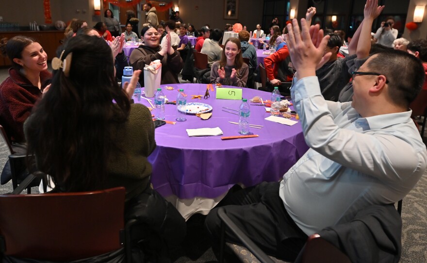 Table 9 cheers after winning the chopstick competition.