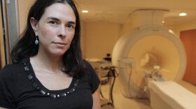 Sian Leah Beilock, then University of Chicago professor, poses for a photograph near a MRI brain scanner, July 16, 2012 in Chicago. Beilock, a leading expert on the brain science, will become the first woman president at Dartmouth in its over 250-year history on July 1, 2023, succeeding Philip J. Hanlon. (AP Photo/M. Spencer Green, File)