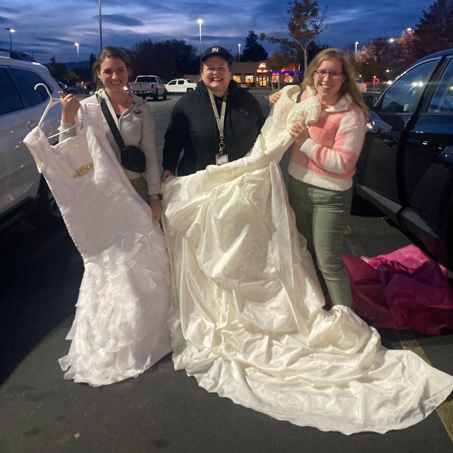 Emily Ruiz (right) got married in the same week as her sister (left), so they donated their wedding dresses to Analane Powell (center) together.