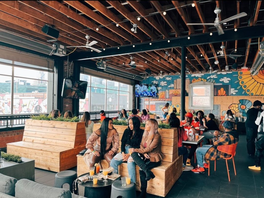 Parlor's huge, enclosed balcony faces west into the city, making it the perfect place to watch a sunset.