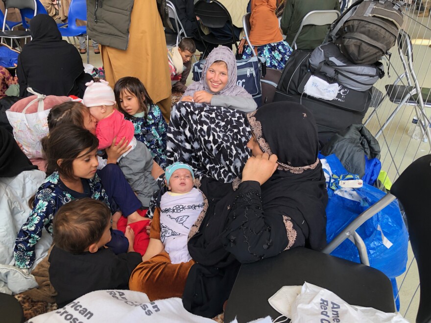 A 15-day-old baby waits with his mother and siblings at Ramstein for a flight to the United States. The family fled Afghanistan because the baby's father worked for the Afghan army before the Taliban took over.