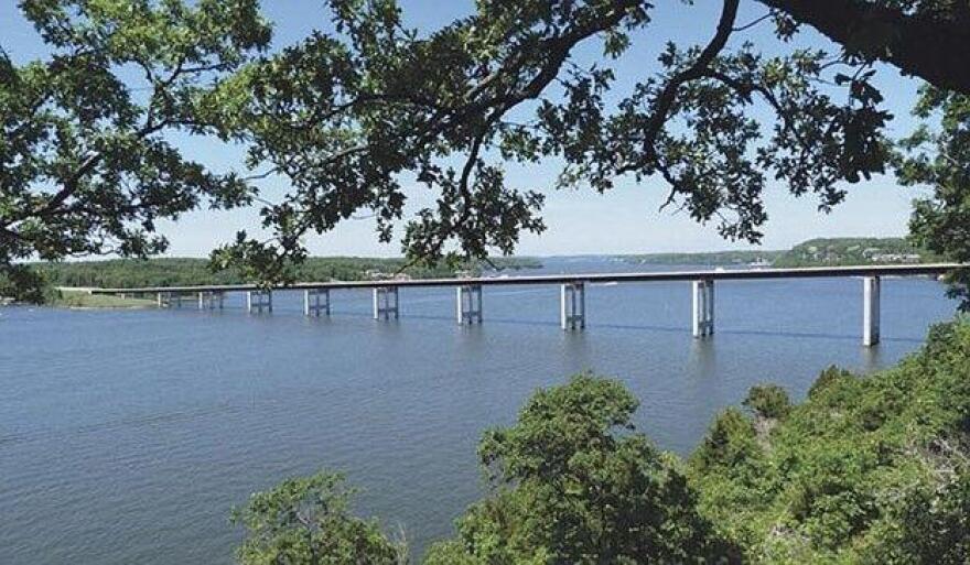 A view of the Lake of the Ozarks Community Bridge through trees.