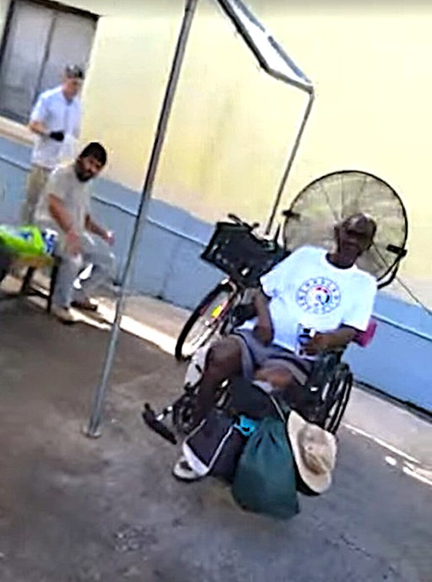 At the Christian Service Center for the Homeless in Orlando, volunteers serve iced water, as unhoused and unsheltered residents come to sit in the shade and be relieved from the heat.