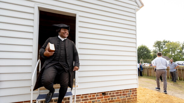 Joe Feaster, a part-time historical interpreter who portrays pastor Gowan Pamphlet, steps out of the reconstructed African Baptist Meeting House, now known as First Baptist Church of Williamsburg, during a rededication ceremony in Williamsburg, Va., Friday, Oct. 9, 2026.