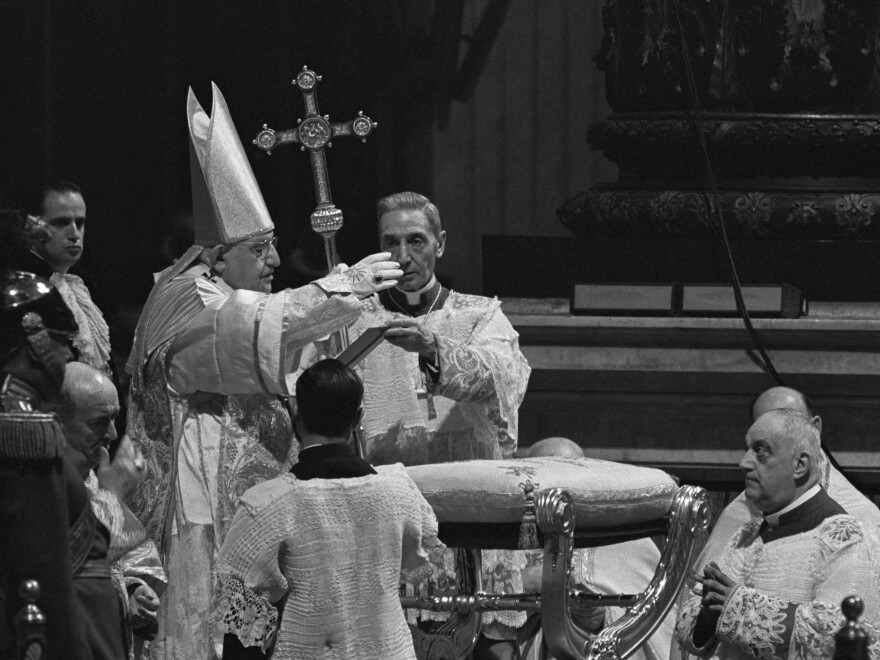 Pope John XXIII waves a hand in blessing during the opening day of Vatican II, on Oct. 11, 1962. The newly elected pope surprised many Catholics by convening the gathering, the first of its kind in nearly a century.