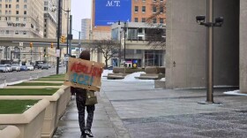 A demonstrator carries a sign reading "abolish ICE" in Detroit on Wednesday, January 28, 2026.