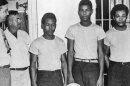 Lake County Sheriff Willis McCall, far left, and an unidentified man stand next to Walter Irvin, Samuel Shepherd and Charles Greenlee, from left, in Florida. The three men along with a fourth were charged with rape in 1949. Florida Gov. Ron DeSantis and a Cabinet granted posthumous pardons Friday, Jan. 11, 2019, to Shepherd, Irvin, Charles Greenlee and Ernest Thomas, the four African-Americans accused of raping a white woman in 1949 in a case now seen as a racial injustice. Relatives of the Groveland Four, as they became known, received restitution totaling $4 million in the 2026-27 Florida budget.