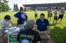 Aaron Schweiger, a Democrat running for Minnesota House District 3B, talks with attendees before canvassing a neighborhood in Two Harbors, Minn., on July 19, 2026.