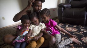 Osman Mohamed, of Somalia, and his three daughters, ages 2, 4 and 5. Osmon hoped to find paradise in Seattle, but in his first year, his family witnessed a shooting and he was hit by a car.
