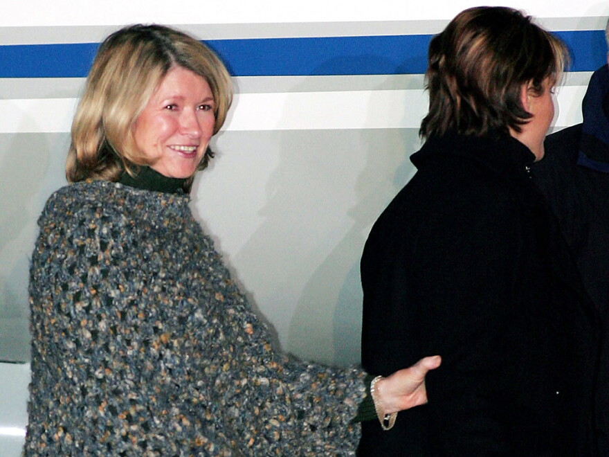 Wearing a poncho, Martha Stewart boards a private jet after being released from prison in Lewisburg, W.Va., March 4, 2005. Stewart completed a five-month sentence for lying to investigators about a stock trade.