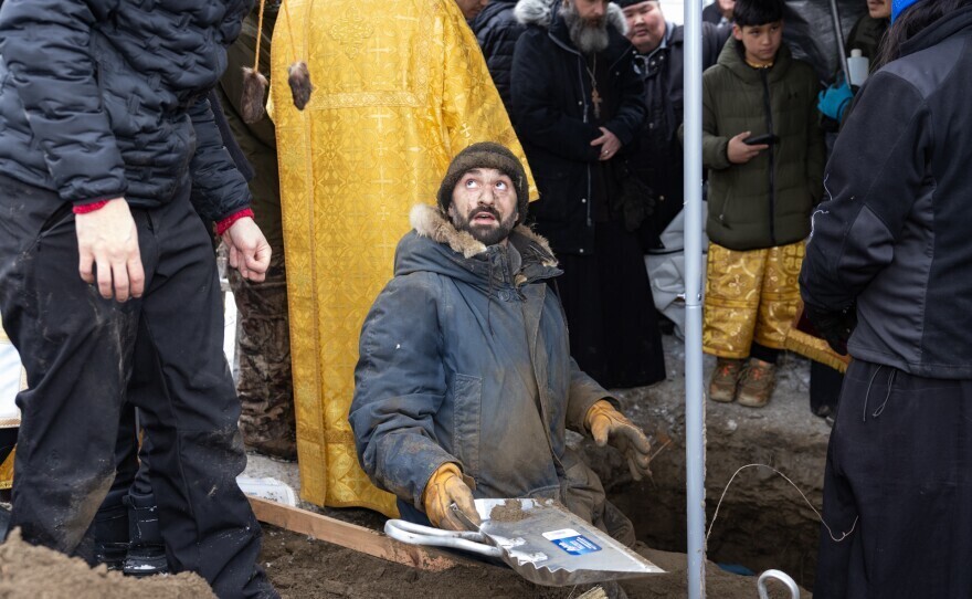 a person stands in a grave