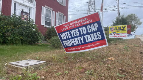 A sign outside of the office of the New Hampshire Republican Party in Concord urging voters to vote "yes" on a school tax cap ballot question this fall.