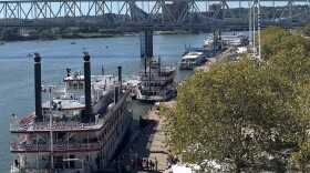 Five riverboats are docked along the Serpentine Wall 