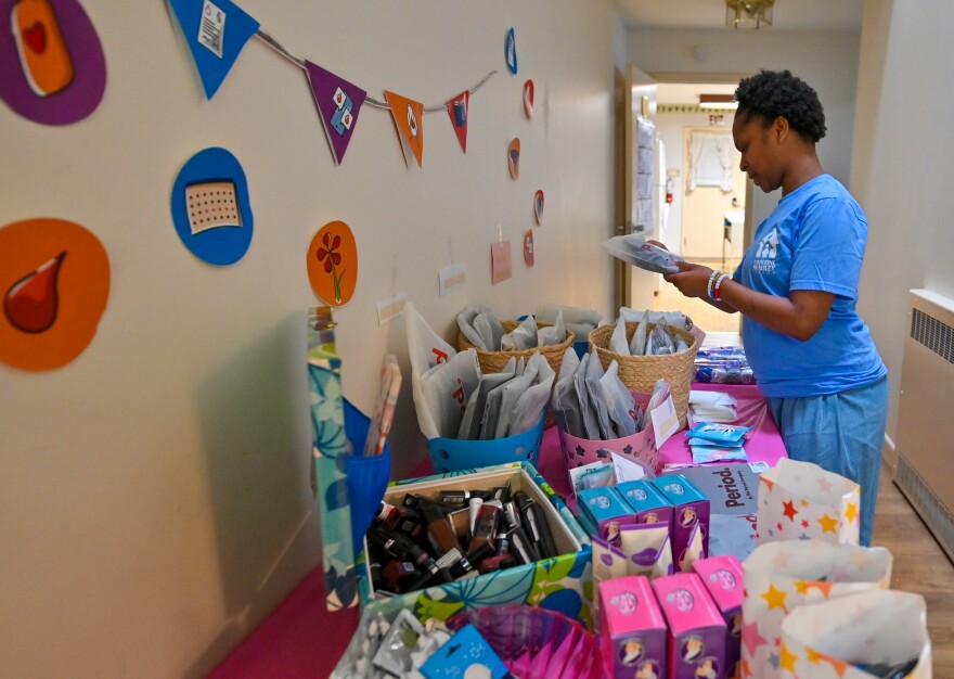 Chyna Heilman looks at period products at the Catherine McAuley Center in Scranton during Menstrual Health Awareness Day on May 28.