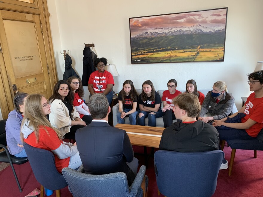 East High School students including Clara Taub (seated on the left side of the couch) and Alaijah Sims (seated on the side table) met with Senate President Steve Fenberg to demand legislative action against gun violence on Thursday, Mar. 23, 2023.