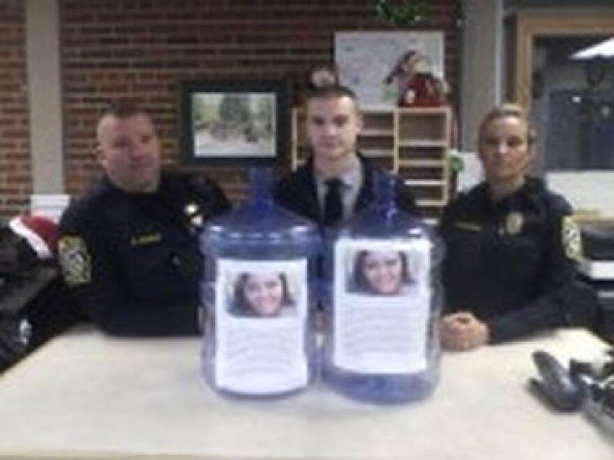 Gates Police Officer Shawn O'Mara, Ofc. Nick Ventrella and Ofc. Jennifer Skidmore preparing donation bottles.