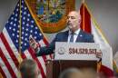 Florida Chief Financial Officer Blaise Ingoglia holds a sign showing the amount of money he claims the city of Miami is overspending in its 2025 budget. Ingoglia spoke at a press conference at the Rohde Building in downtown Miami on Thursday, Oct. 23, 2025.